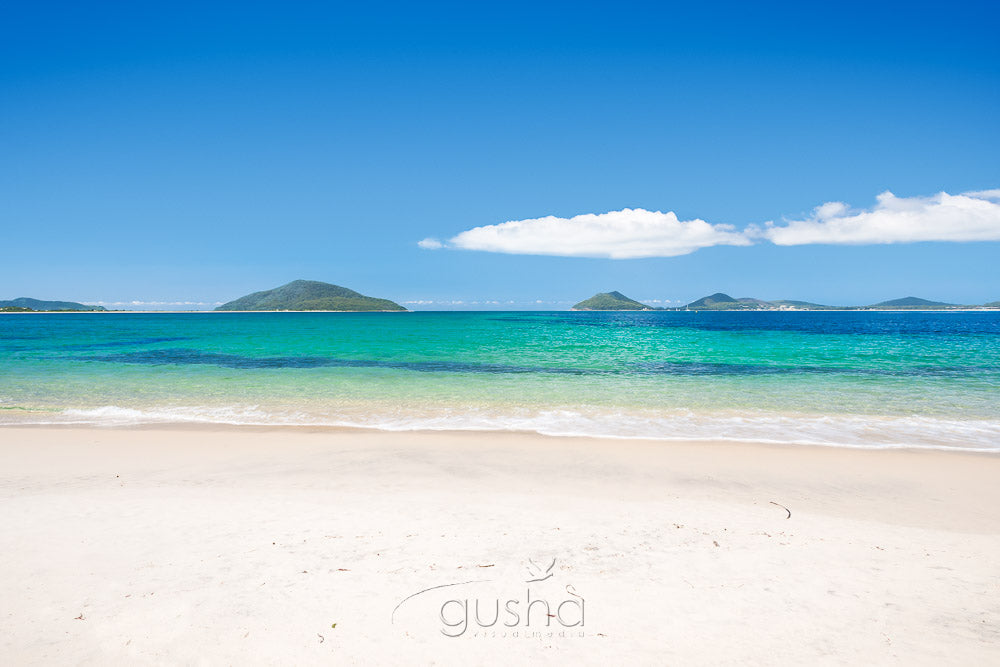 A photo capturing the view across Jimmys Beach towards Shoal Bay in the distance.
