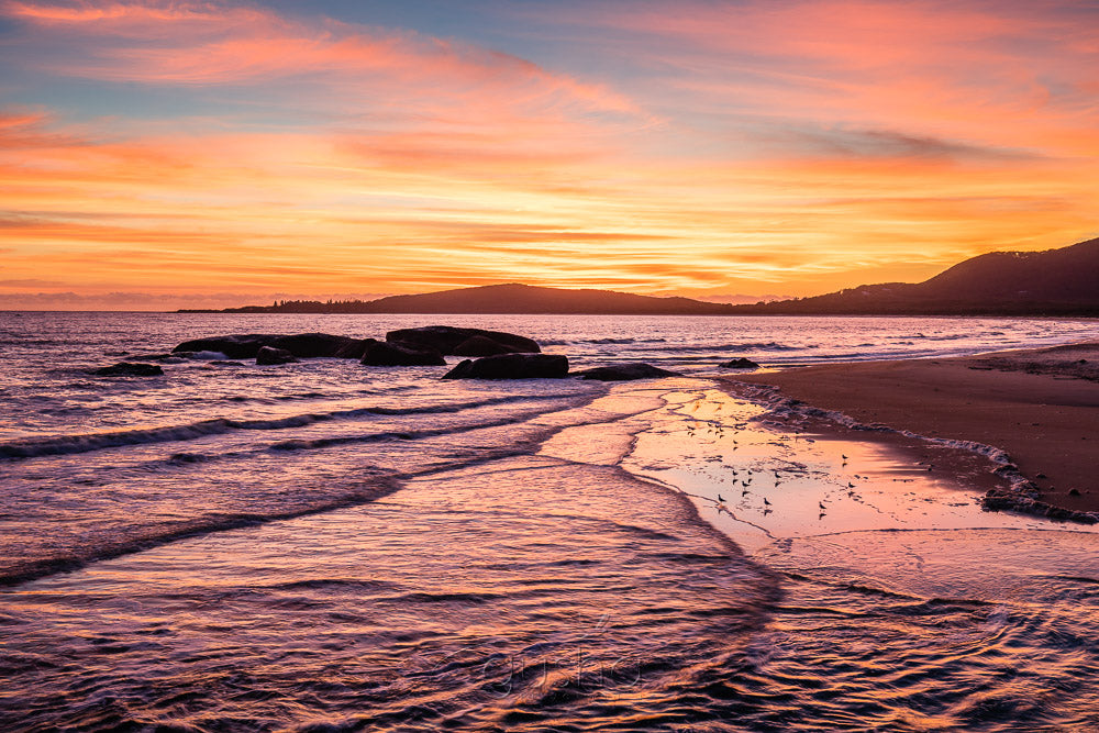 A big sunrise dominates the sky over Front Beach at South West Rocks.