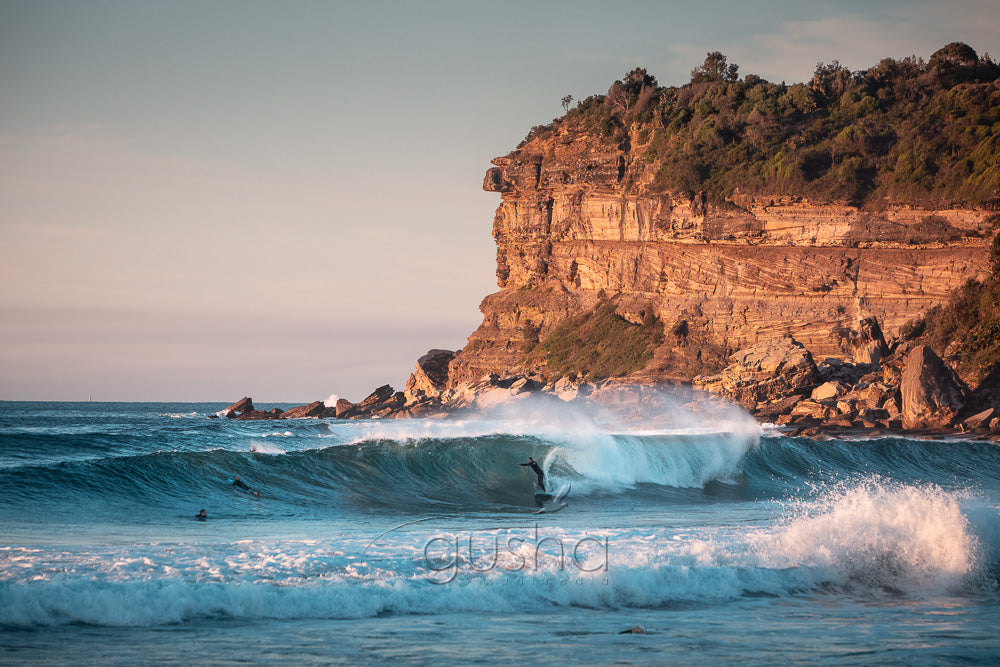 A photo of a surfer on a wave at Avalon Beach in Sydney, Australia.