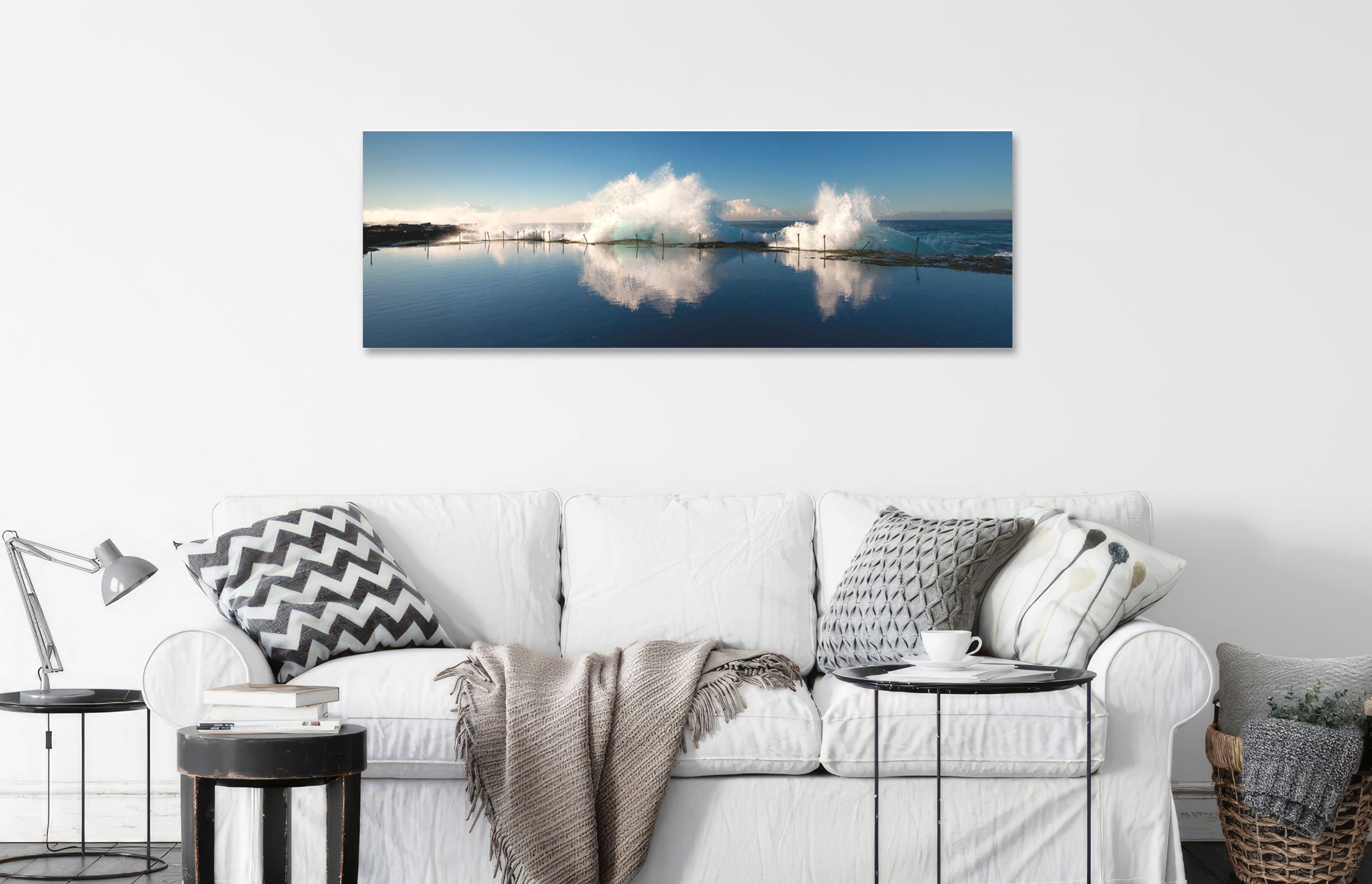 'Glass' print hung over white sofa featuring a ocean pool photo