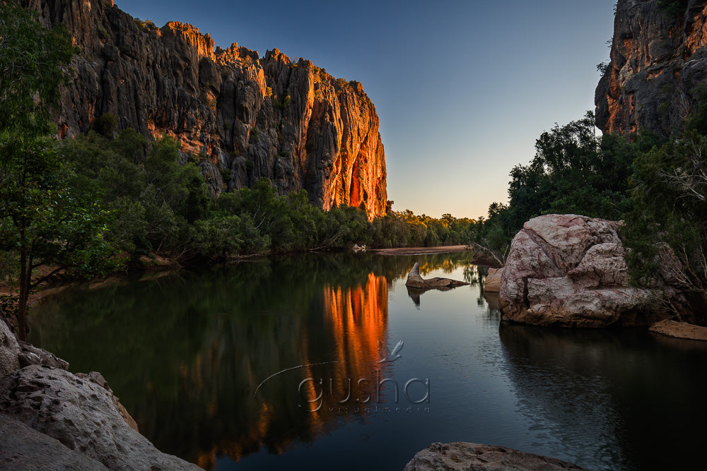 This breath-taking gorge, rises vertically from otherwise flat, outback landscape. The gorge features many lazy, freshwater crocodiles, two can be seen resting on a rock near the centre of this photo.