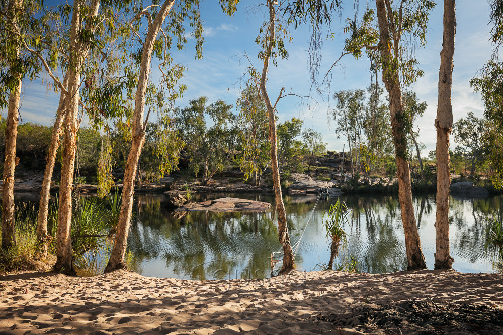 The oasis near Manning Gorge camp grounds provides welcome relief from the heat of the outback sun. The rope across the water simplifies the crossing in a small dingy and marks the beginning of the half day trek to Manning Falls.