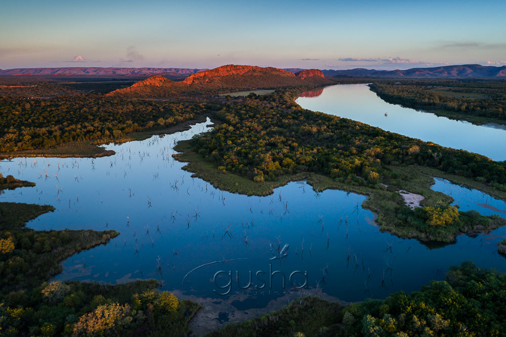 The last light of day bathes the quiet tributaries of Lake Kununurra.