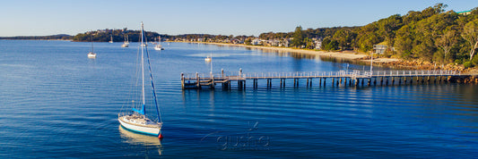 Captured near Soldiers Point, this photo shows Salamander Bay wharf with Wanda Beach on the horizon.