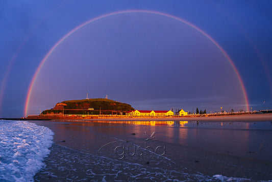 A photo of a rainbow over Nobbys Beach in Australia