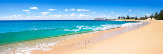 A perfect shorebreak rolls onto the sands of Collaroy Beach.