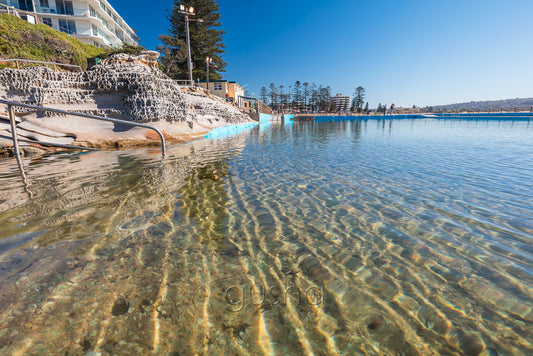 A photo of clear sparkling water at the edge of Dee Why Pool in Sydney, Australia.
