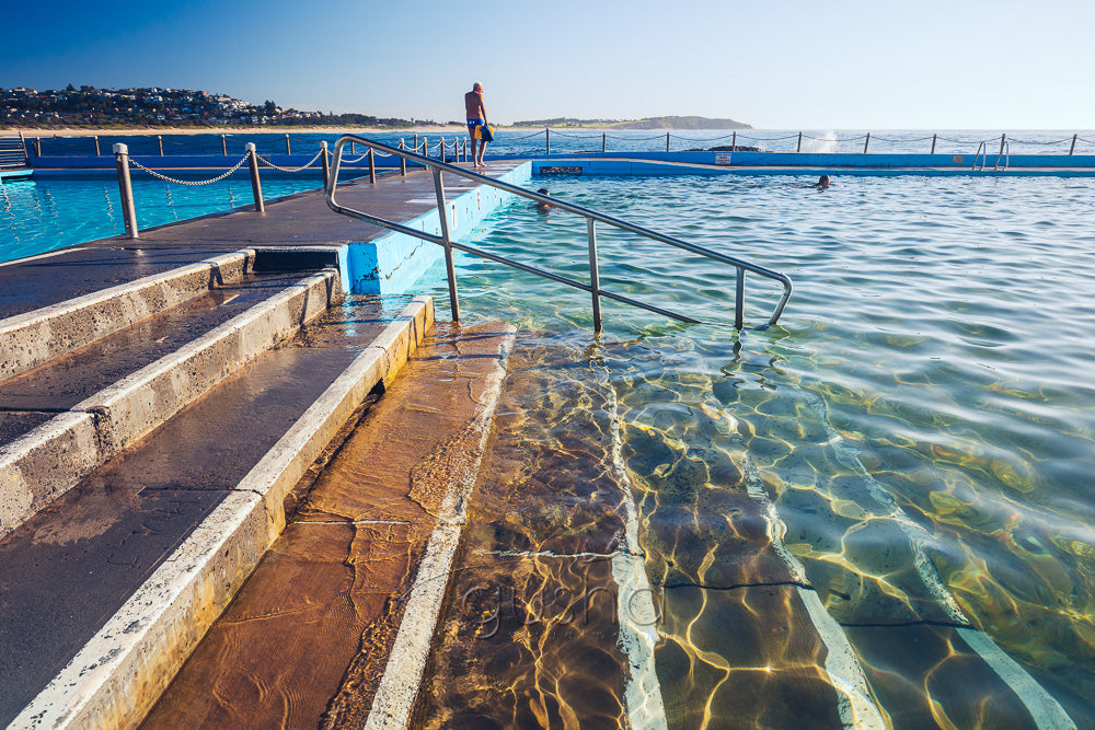 A photo of steps into sparkling water at the edge of Dee Why Pool in Sydney, Australia.
