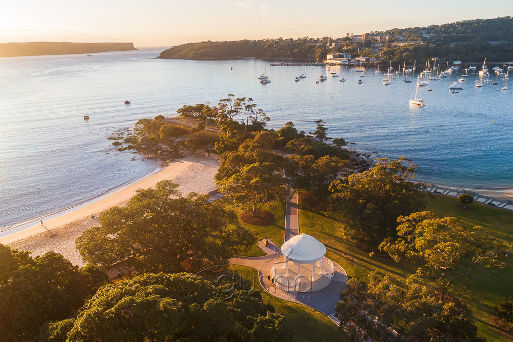 In this photo the early morning sun is rising over the rotunda and Balmoral Beach in Sydney, Australia.