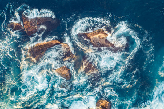An abstract photo of water moving around intertidal rocks at North Curl Curl in Sydney, Australia.