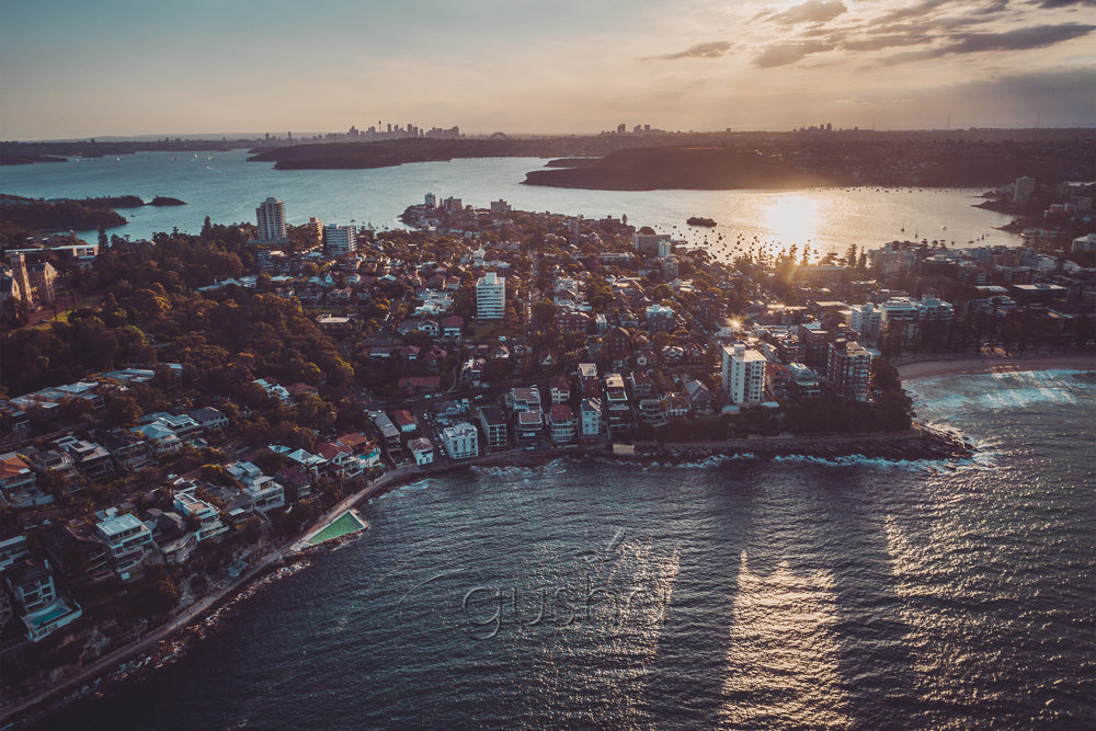 The setting sun casts long shadows in a photo captured high over Manly in Sydney, Australia.